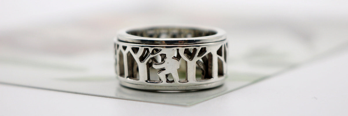 Wide silver spinner ring with a forest cutout