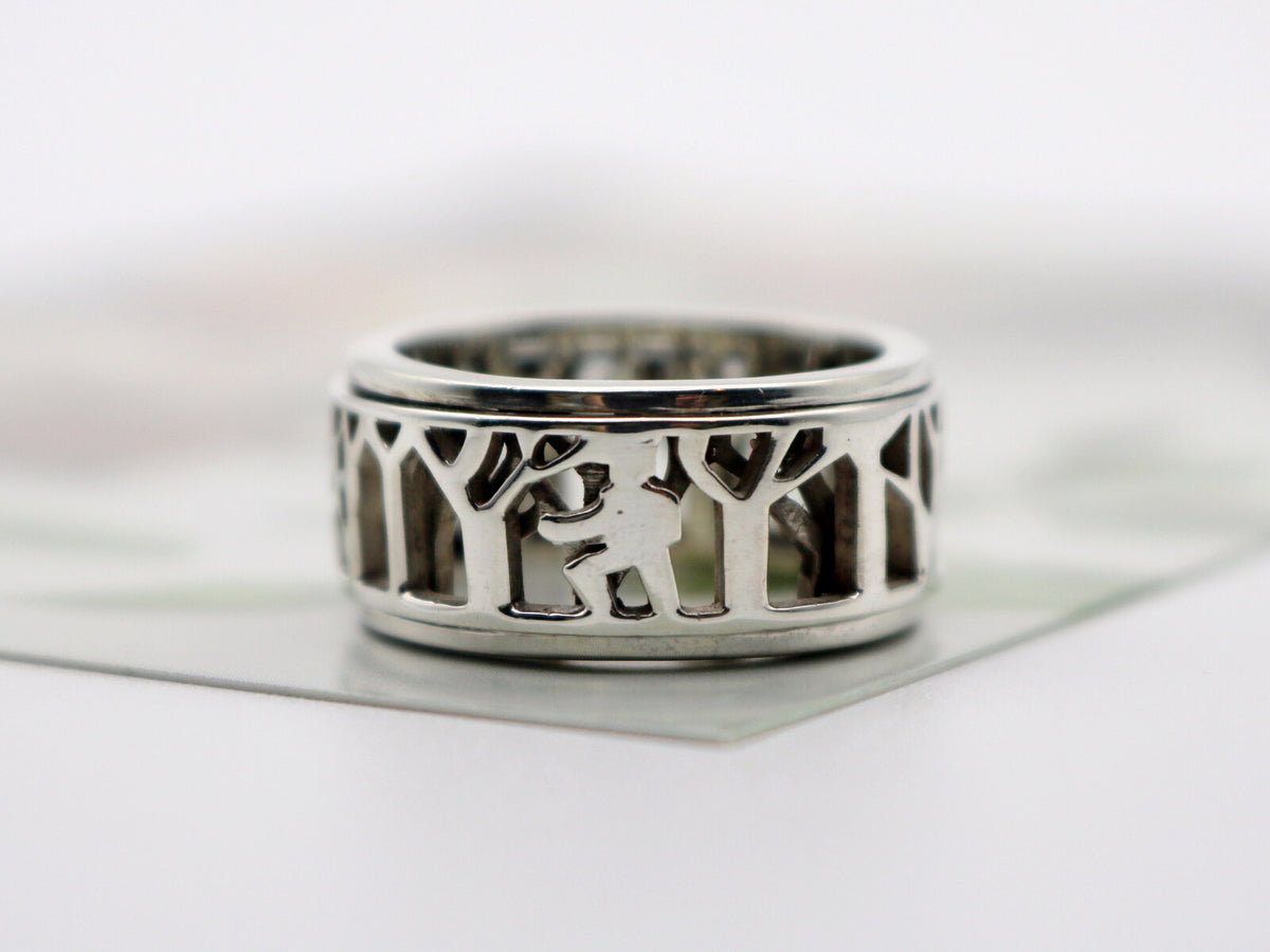 Wide silver spinner ring with a forest cutout