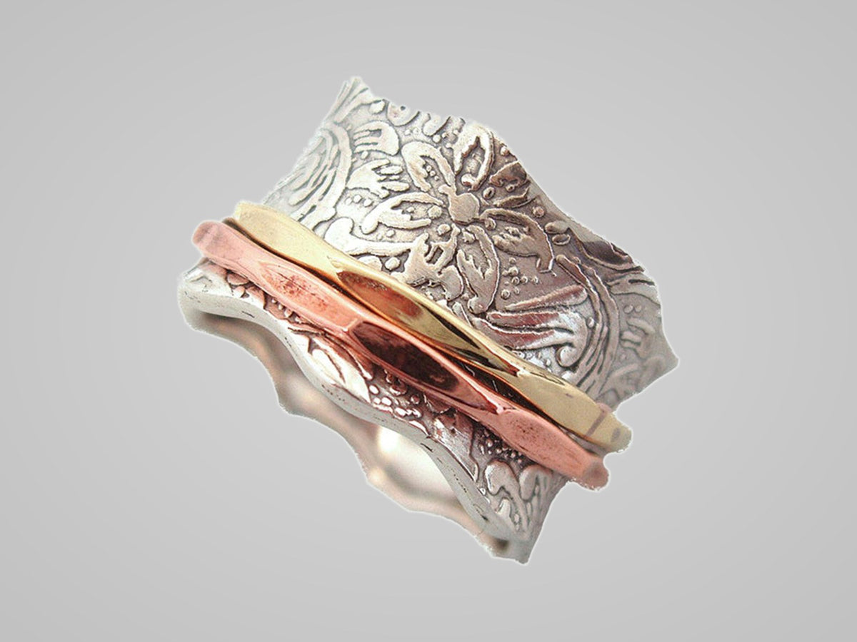 Balance and Beauty floral spinner ring with silver, gold and copper bands