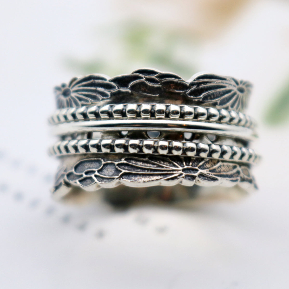 Chrysanthemum sterling silver spinner ring by Energy Stone